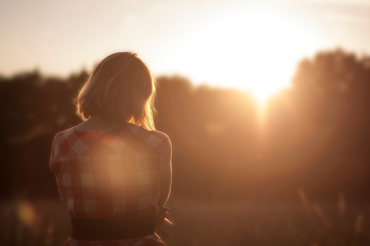 A traveler bathed in golden-hour light, representing a life lived without borders