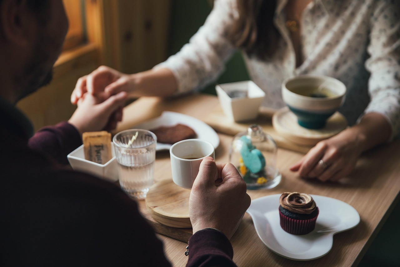 Two friends sharing a warm moment together over coffee