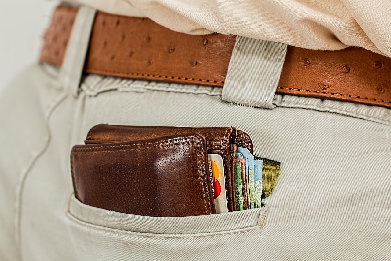 Cash and cards held in a leather wallet, representing the ability to hold multiple currencies at once